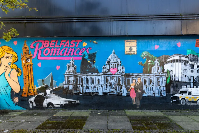 A wall in Belfast with colourful artwork under the title 'Romance'
