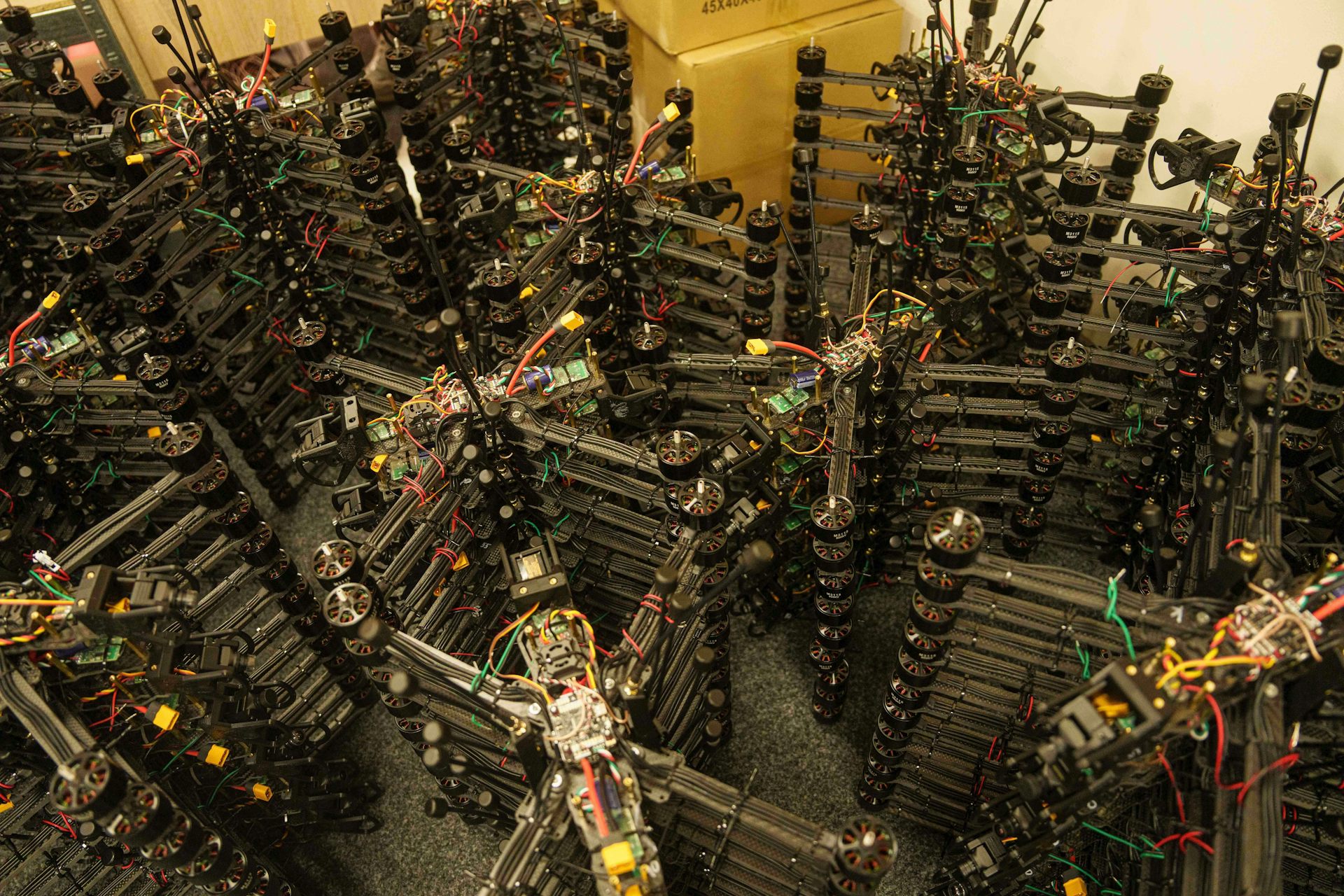 Stacks of drones piled on top of each other in a warehouse