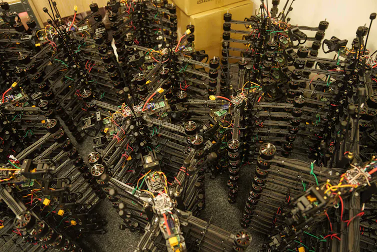 Stacks of drones piled on top of each other in a warehouse