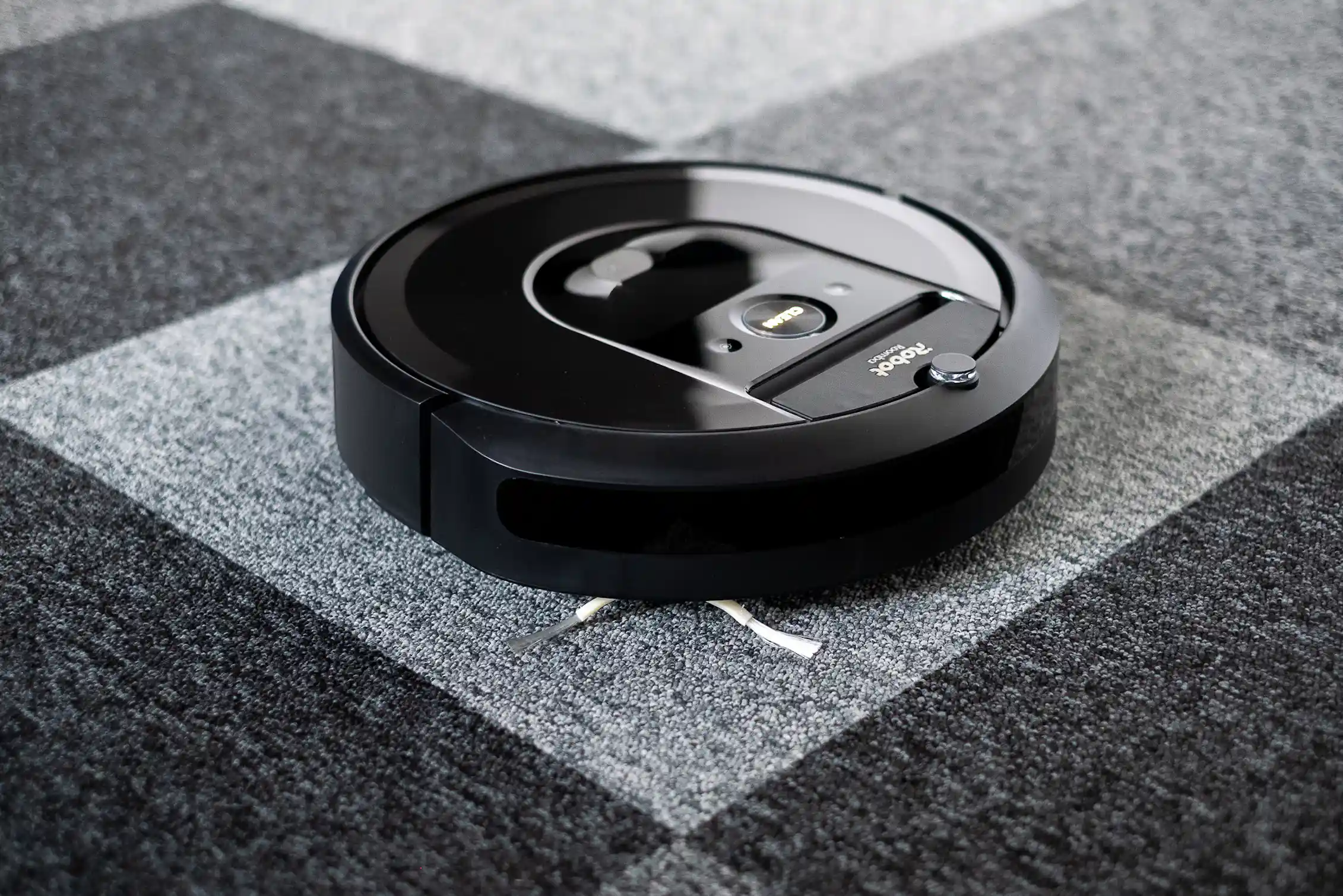 a disk-shaped device on a carpeted floor