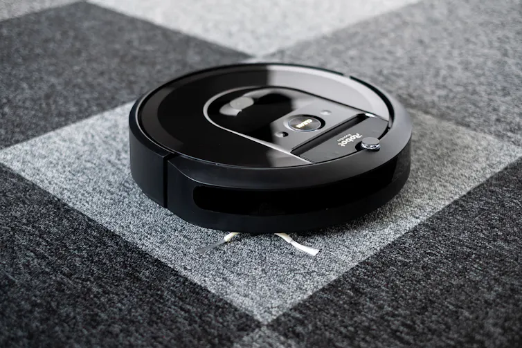 a disk-shaped device on a carpeted floor