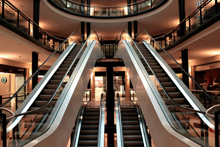 Escadas rolantes dentro de um shopping center vazio.