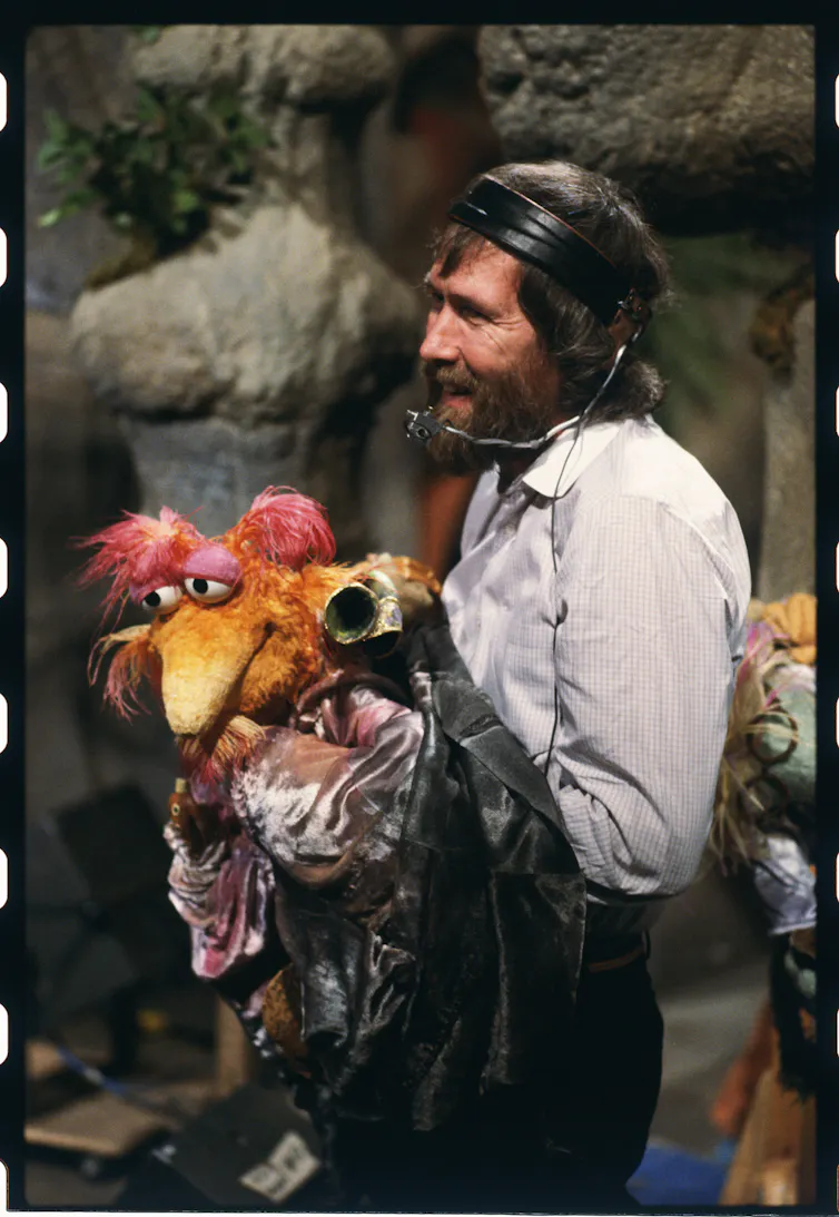 Henson with a puppet.
