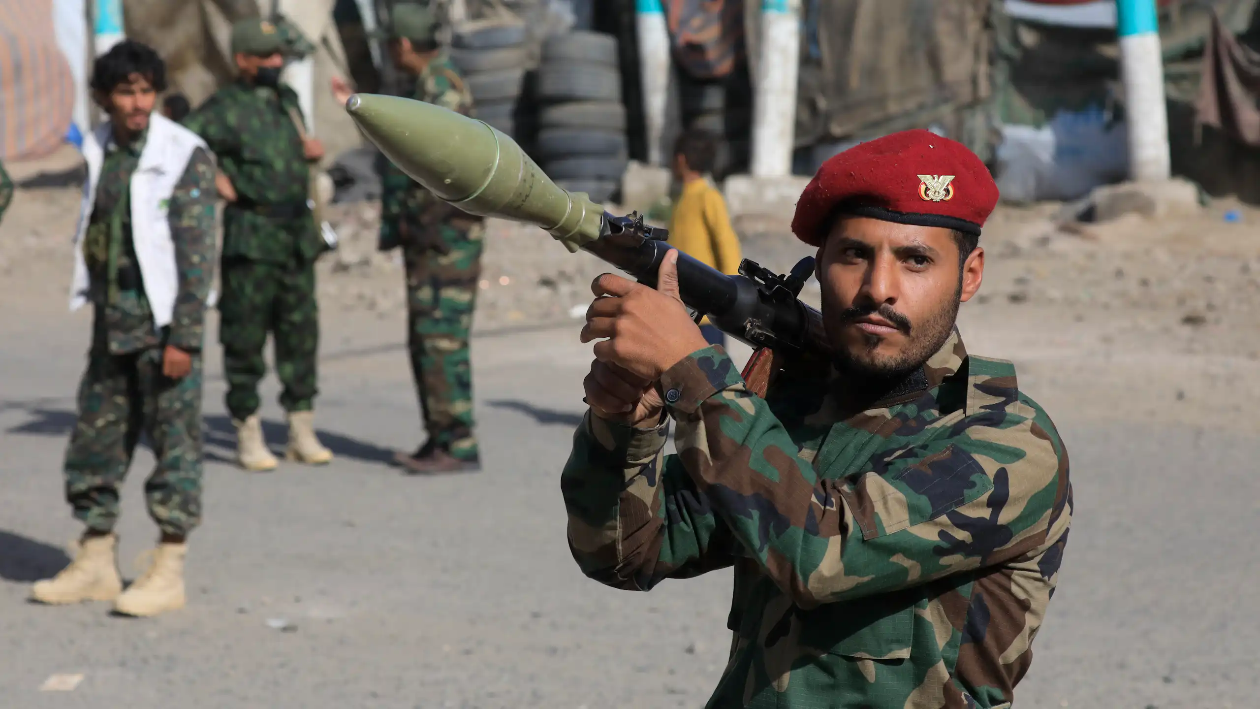 A Houthi fighter carries a rocket-propelled grenade launcher.