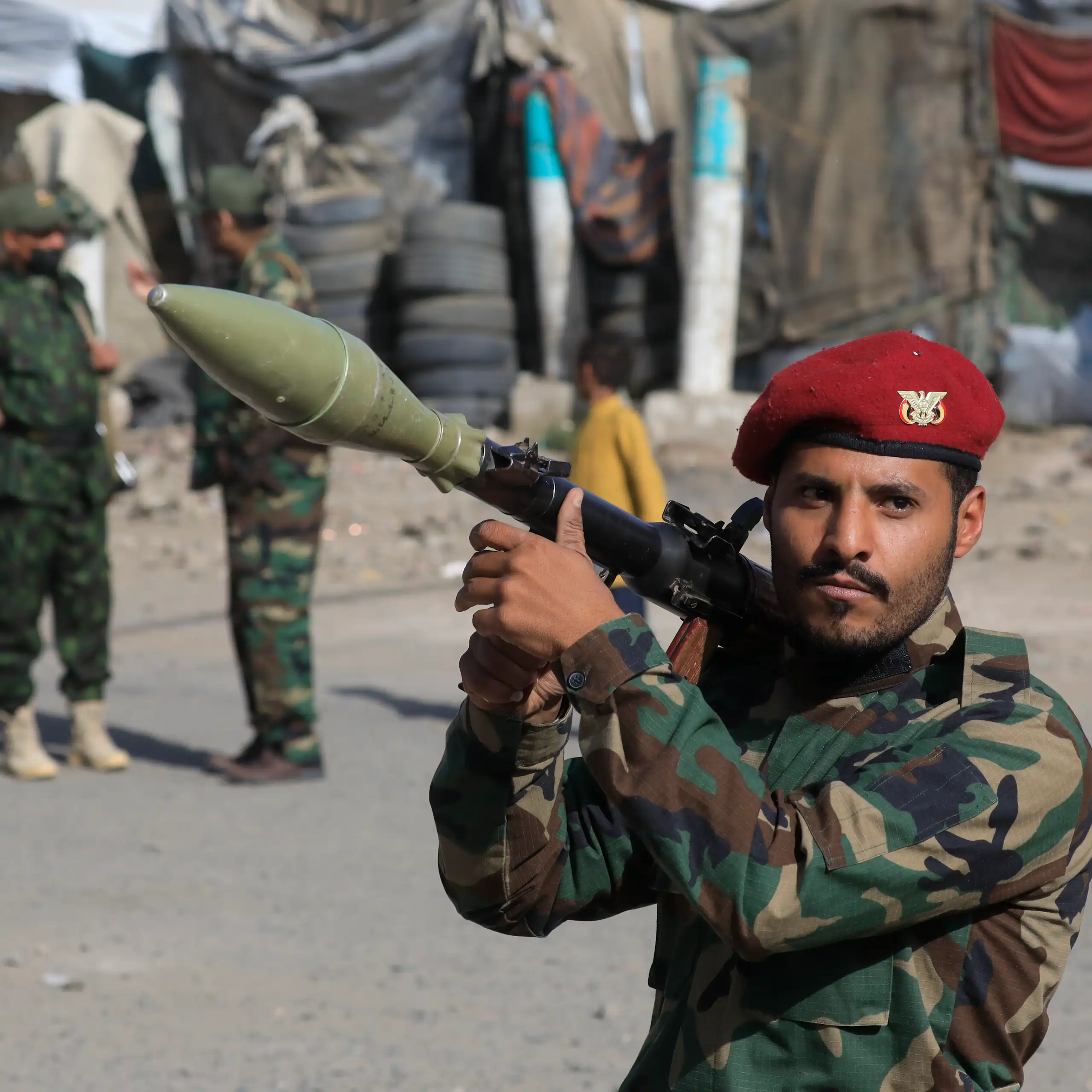 A Houthi fighter carries a rocket-propelled grenade launcher.