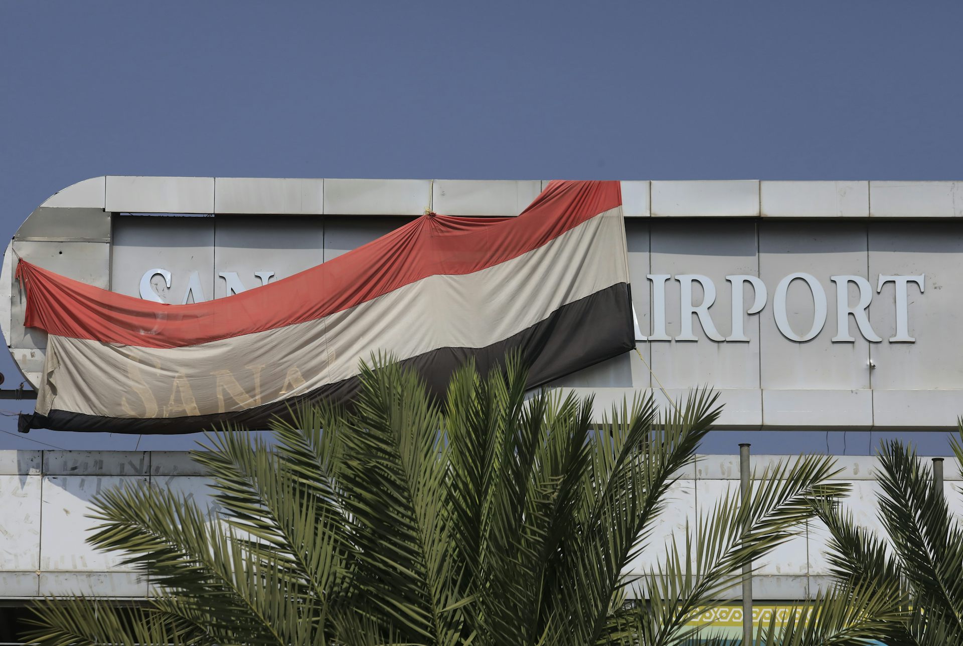 A Yemeni national flag hangs on the main building of Sana'a International Airport.