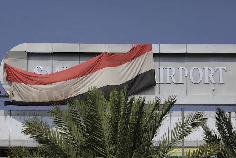 A Yemeni national flag hangs on the main building of Sana'a International Airport.