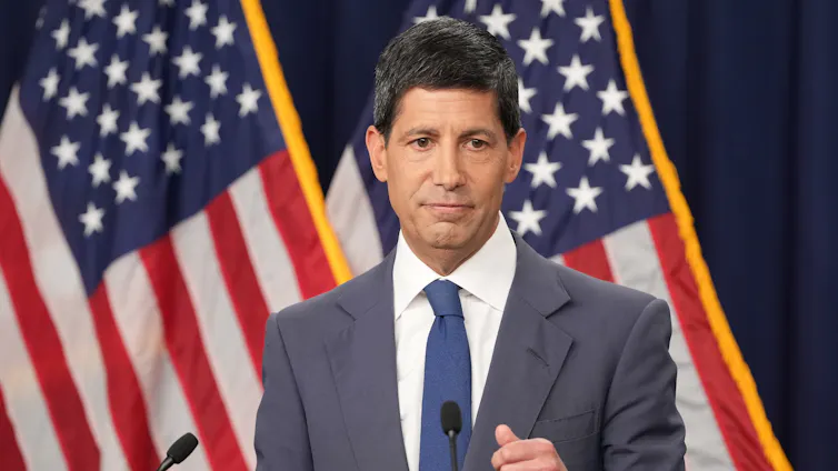 Federal Reserve Chair Kevin Warsh, wearing a grey suit and a blue tie, speaks at a news conference in Washington on July 29, 2026.