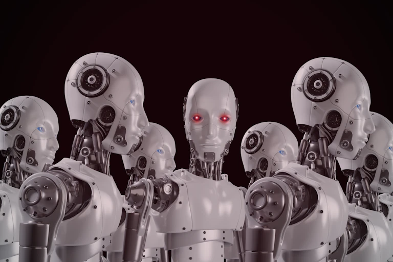 humanoid robots, one looking to camera with red eyes