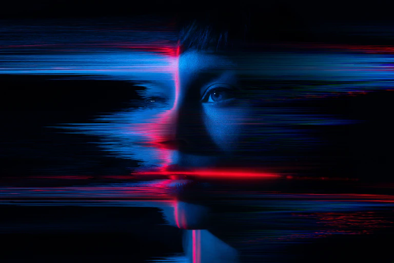 A woman's face digitally edited to appear as if it's dissolving.