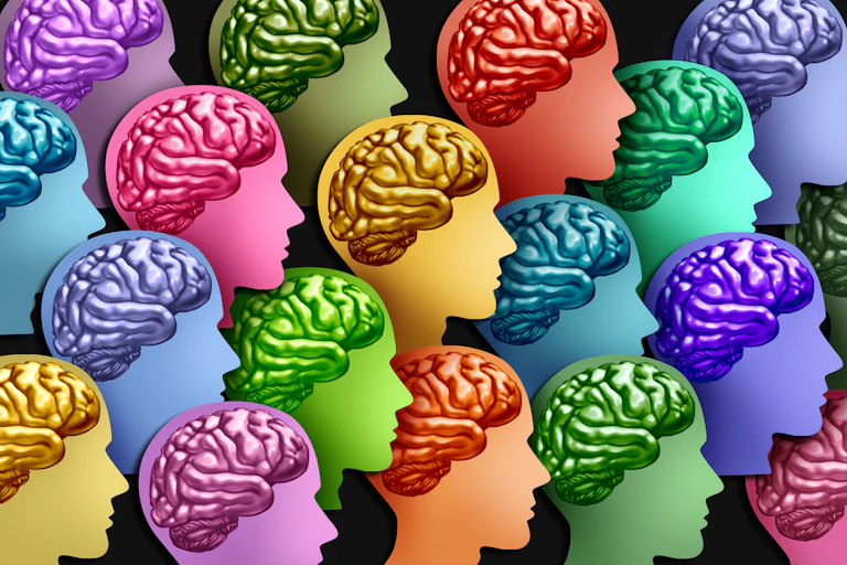 A collection of silhouetted heads with anatomically correct brains in various different colours.