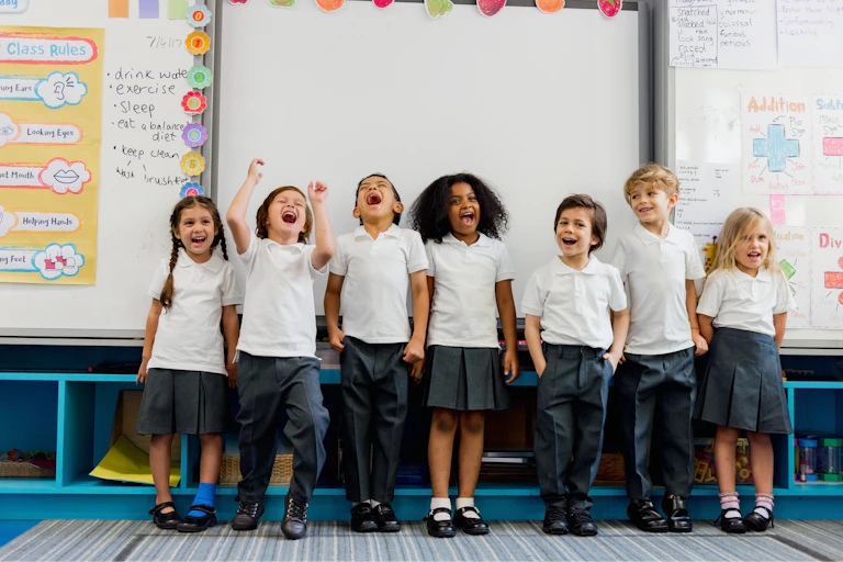 Happy primary school children in line in classroom