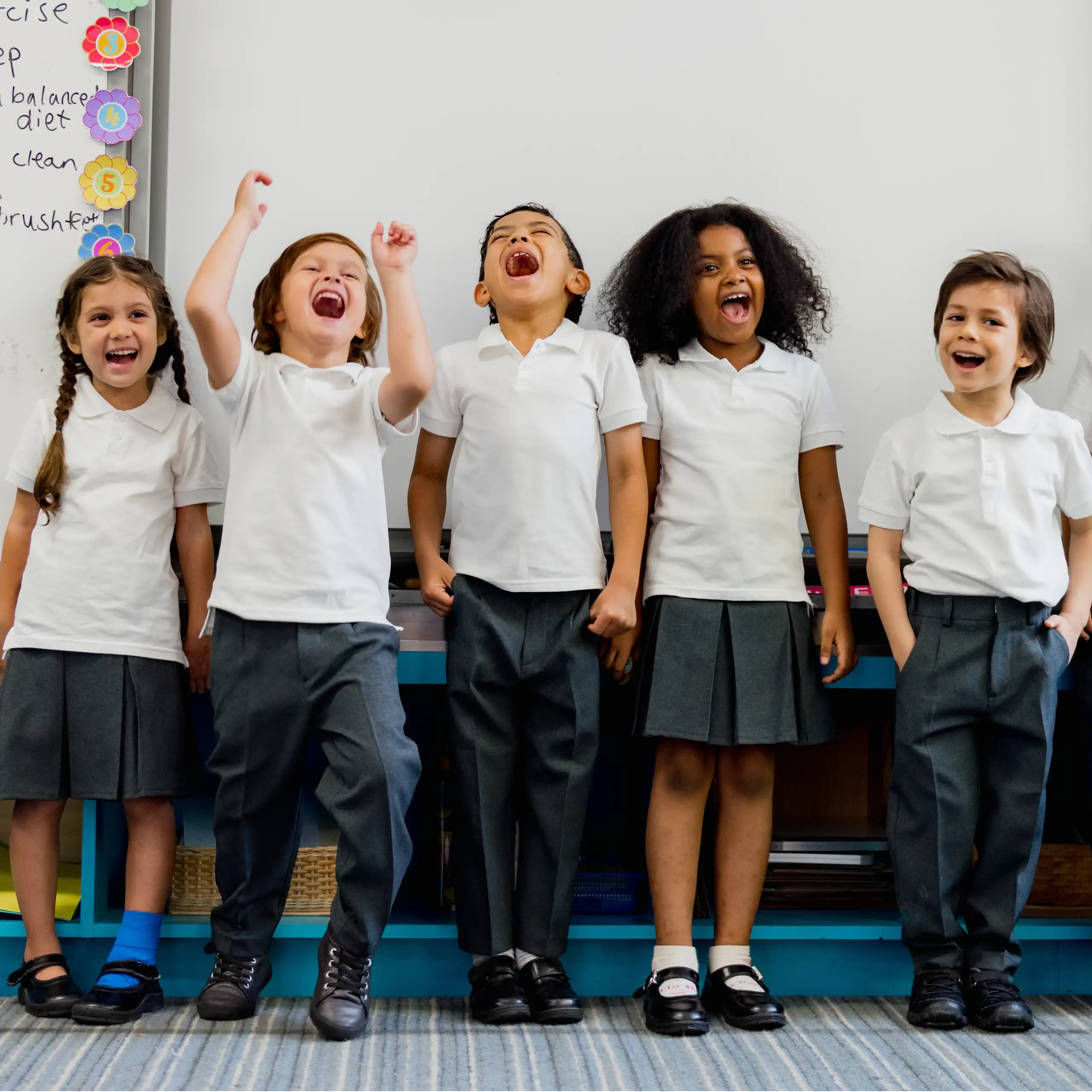 Happy primary school children in line in classroom