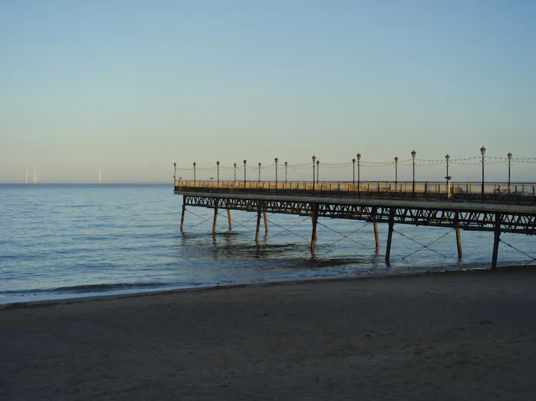 A pier on a calm sea.