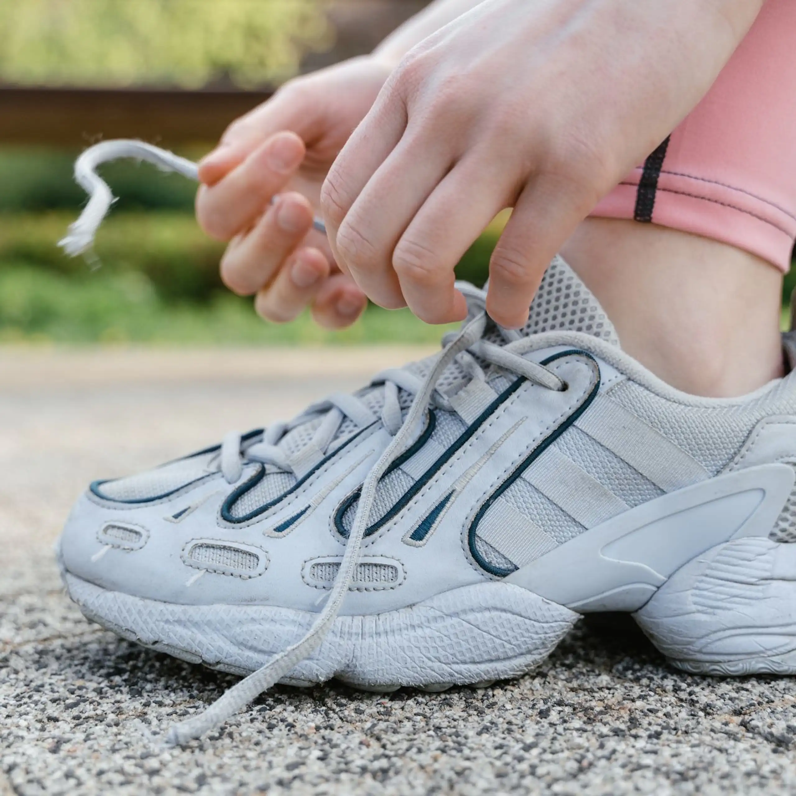 Uns sportive lace ses chaussures.