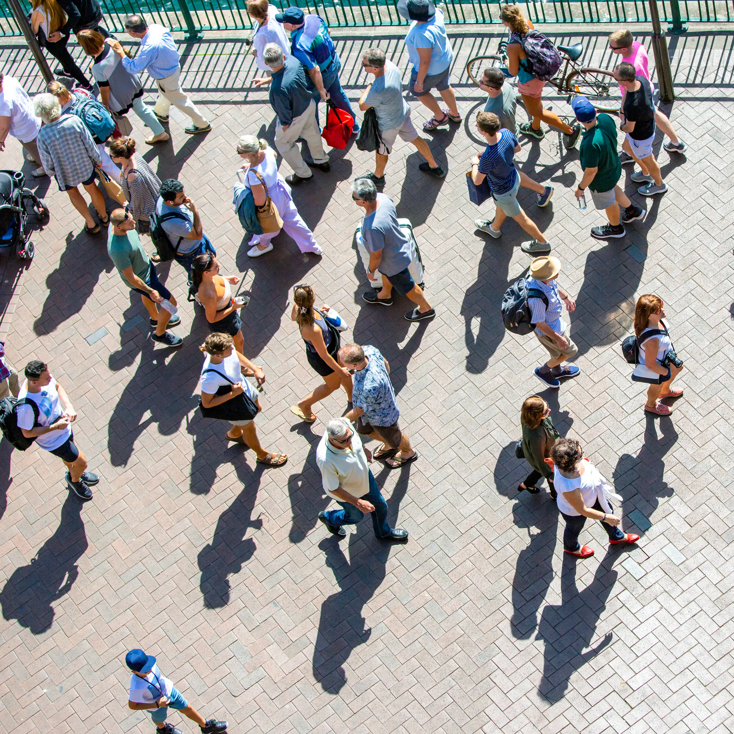 An aerial view of a crowd of people walking a city street