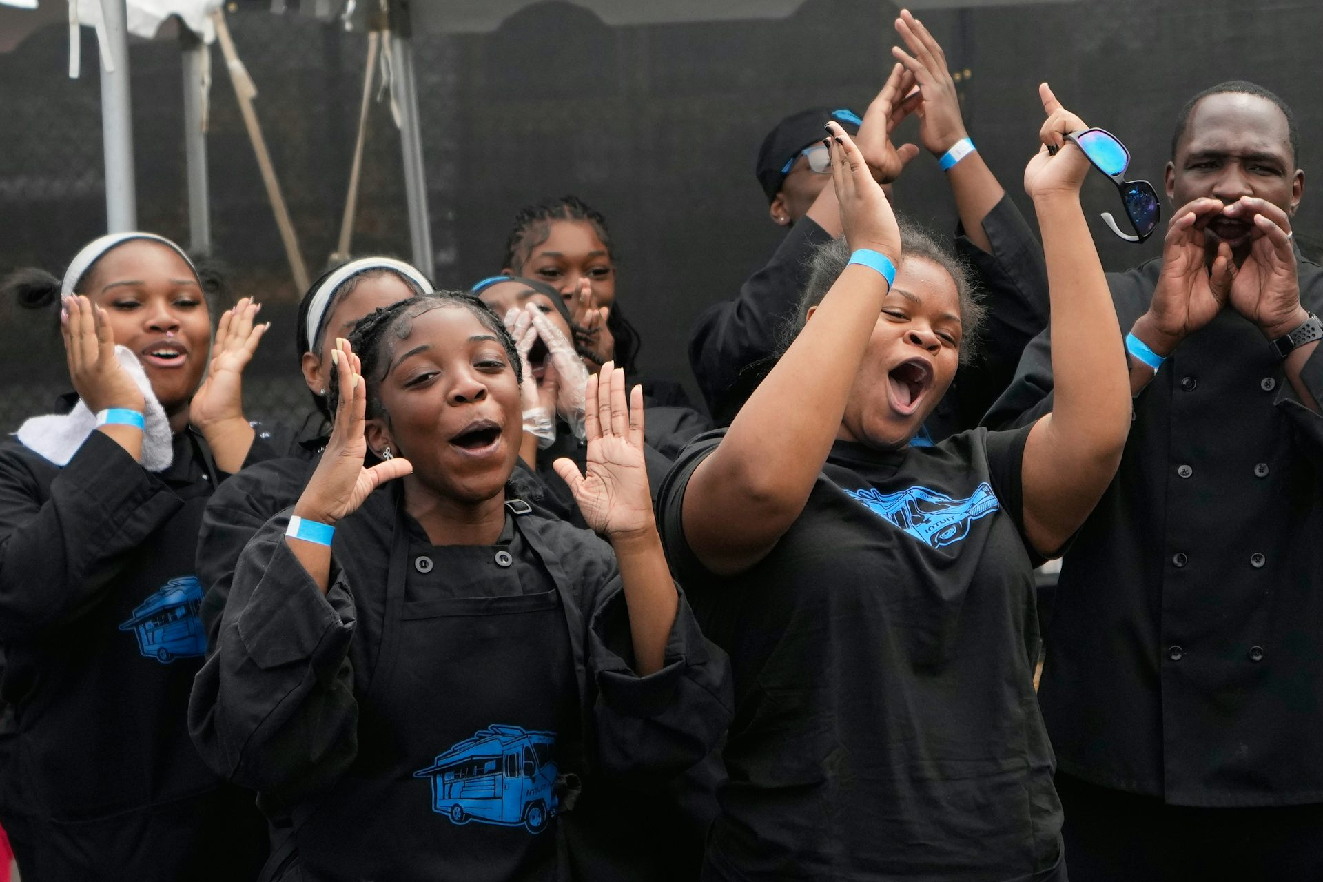 Young women cheer and clap.