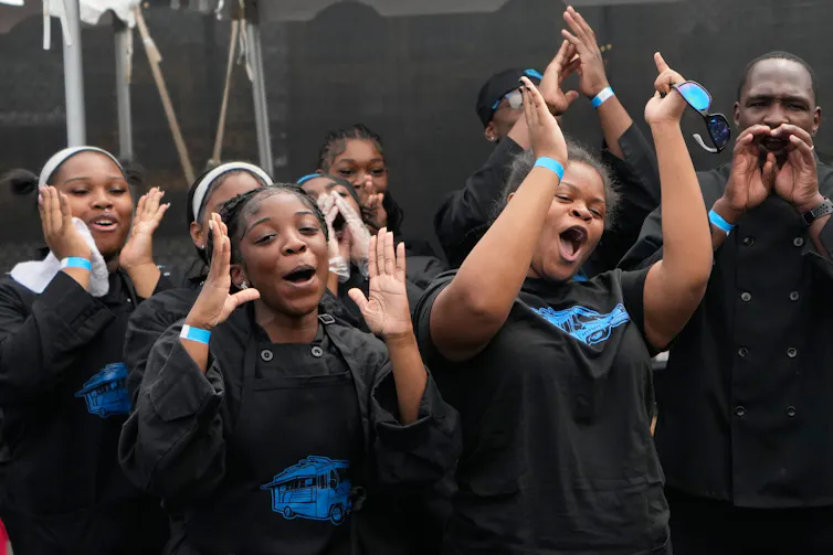 Young women cheer and clap.