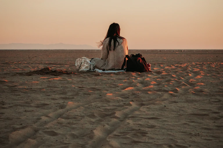 Woman sitting alone on the beach