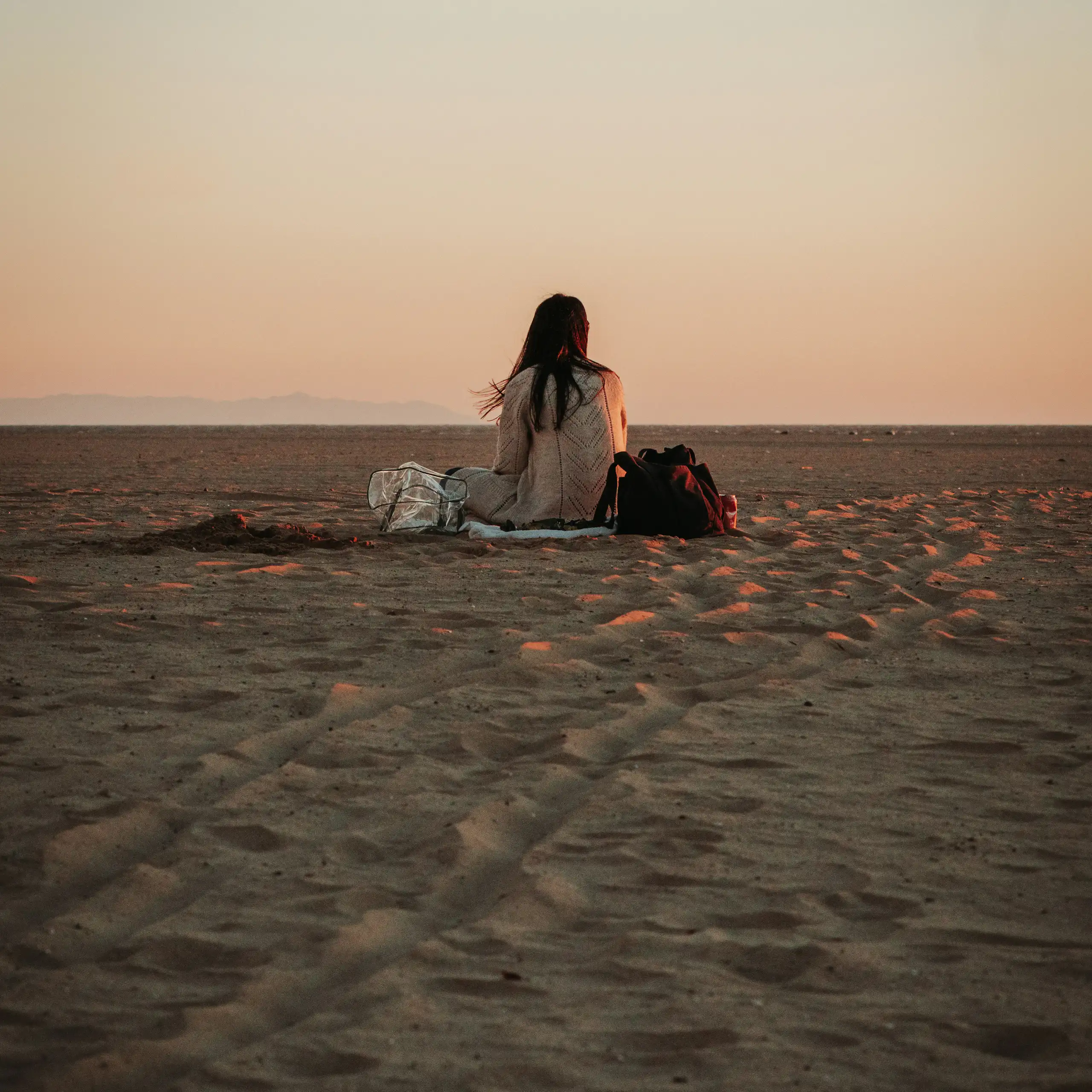 Woman sitting alone on the beach