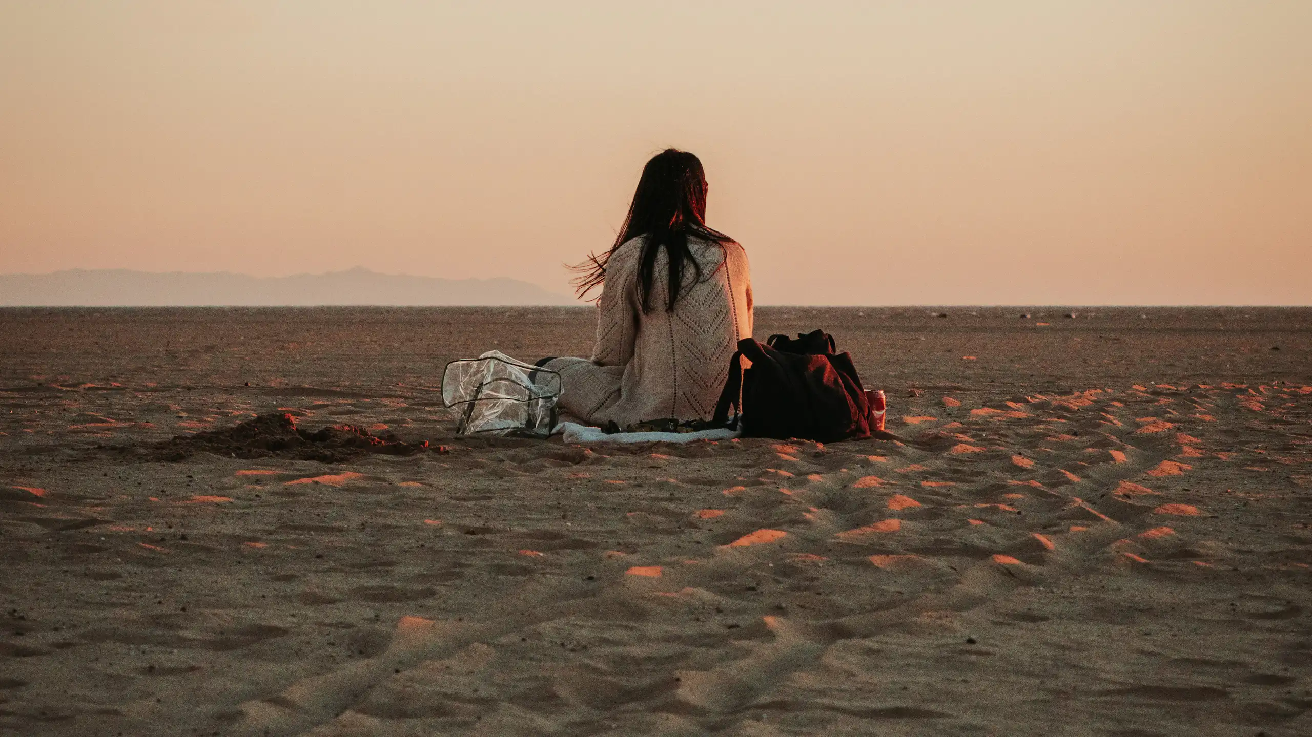 Woman sitting alone on the beach