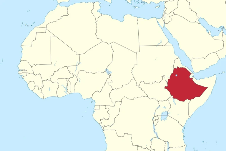A light yellow map of Africa with a blue sea and blue national border lines, Ethiopia highlighted in red.
