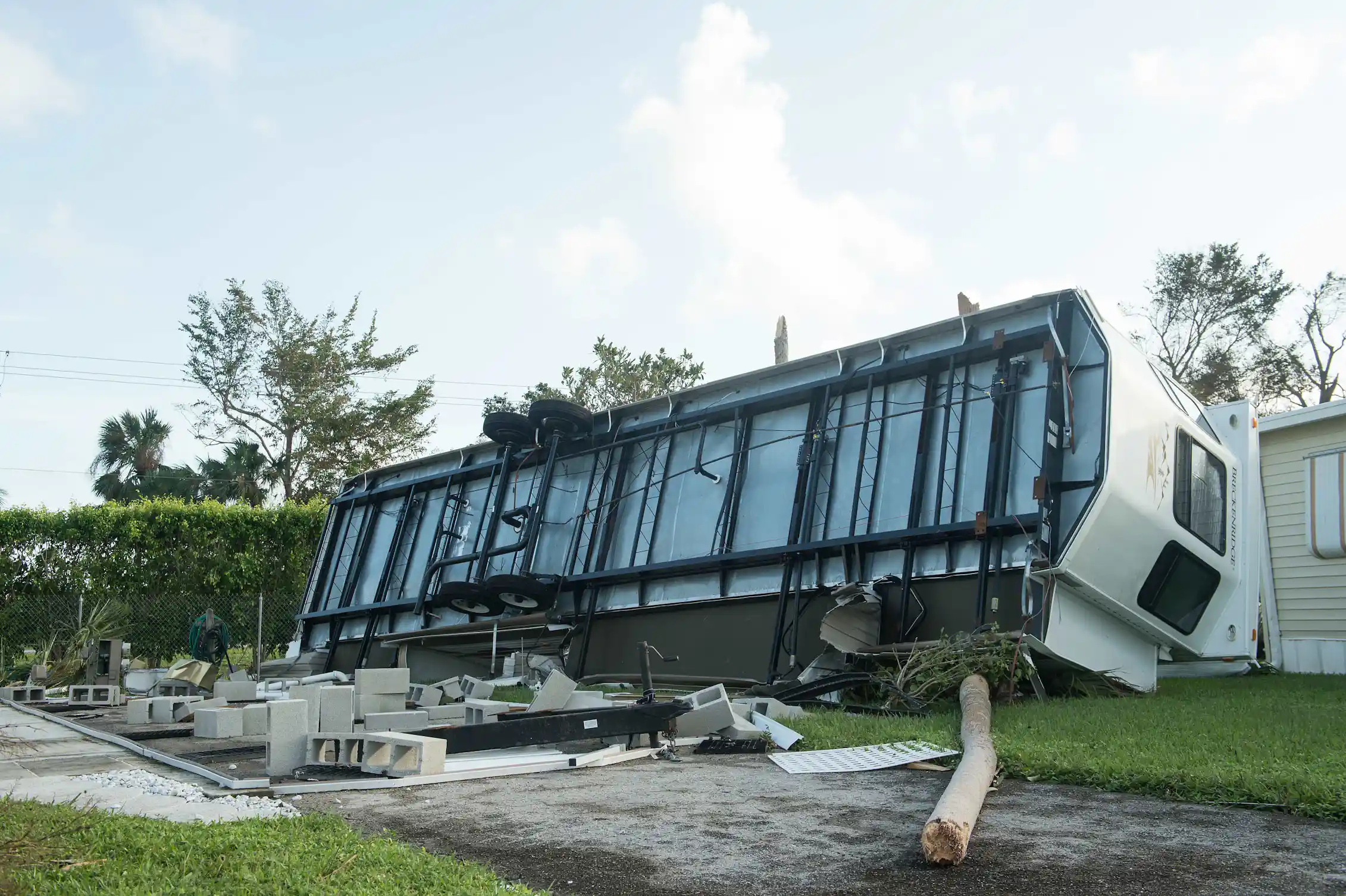 A mobile home rolled on its side with the bottom showing