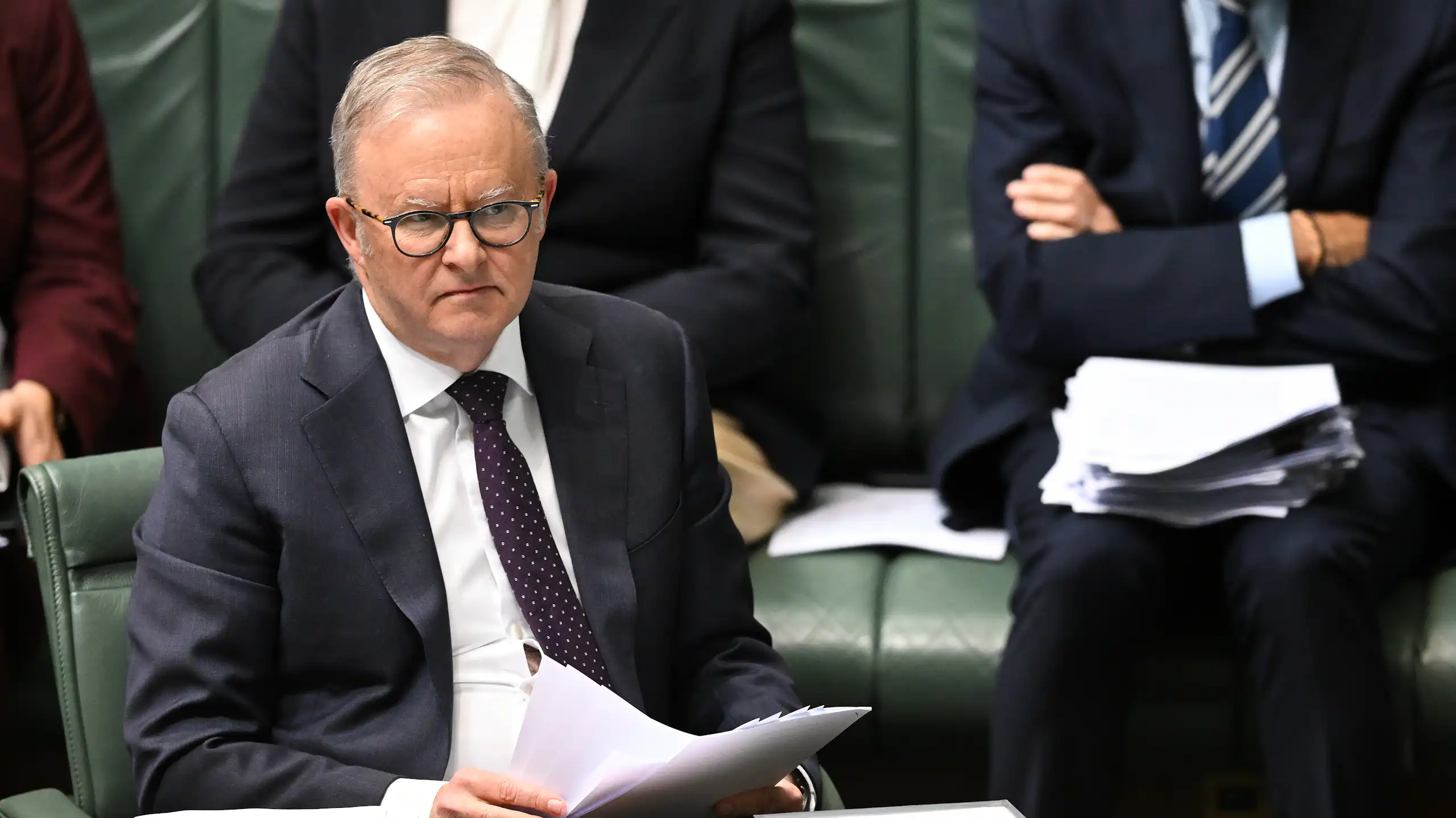 Anthony Albanese sits in the House of Representatives and frowns