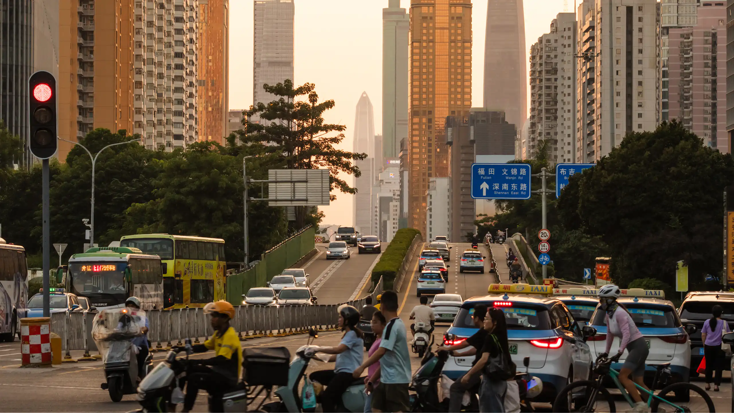 urban scene in China, electric scooters and cars with skyscrapers behind
