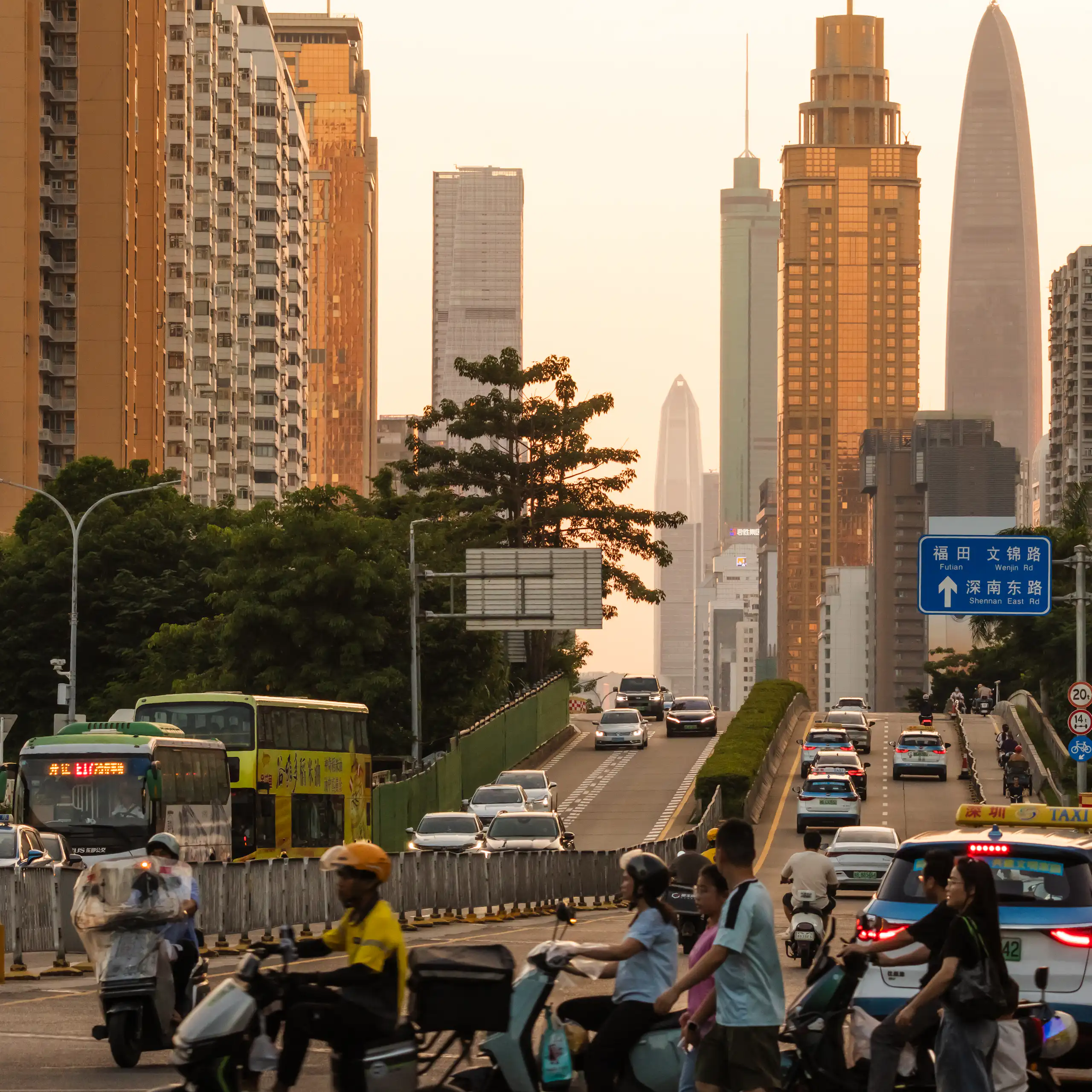 urban scene in China, electric scooters and cars with skyscrapers behind