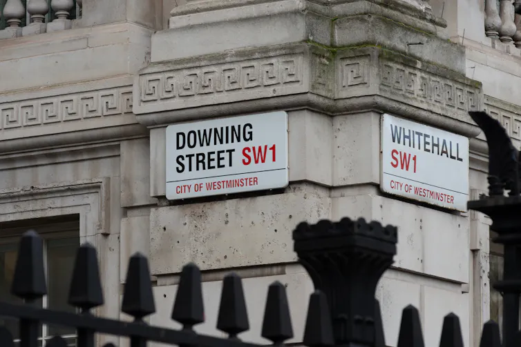 Street signs for Downing Street and Whitehall.