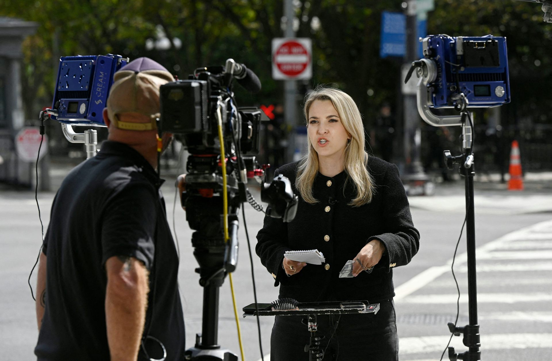 CNN reporter Betsy Klein speaks to camera outside the White House.
