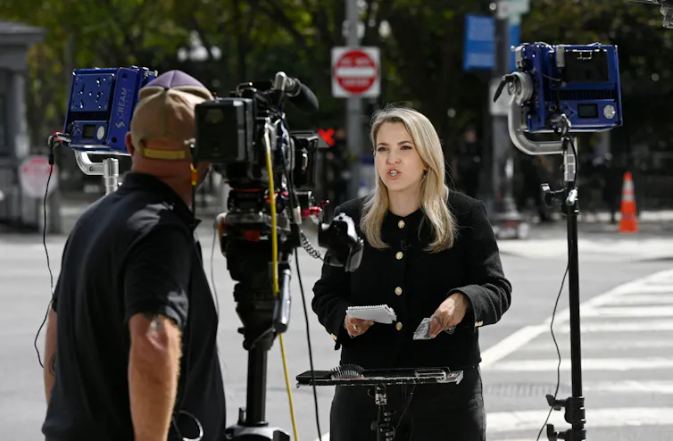 CNN reporter Betsy Klein speaks to camera outside the White House.