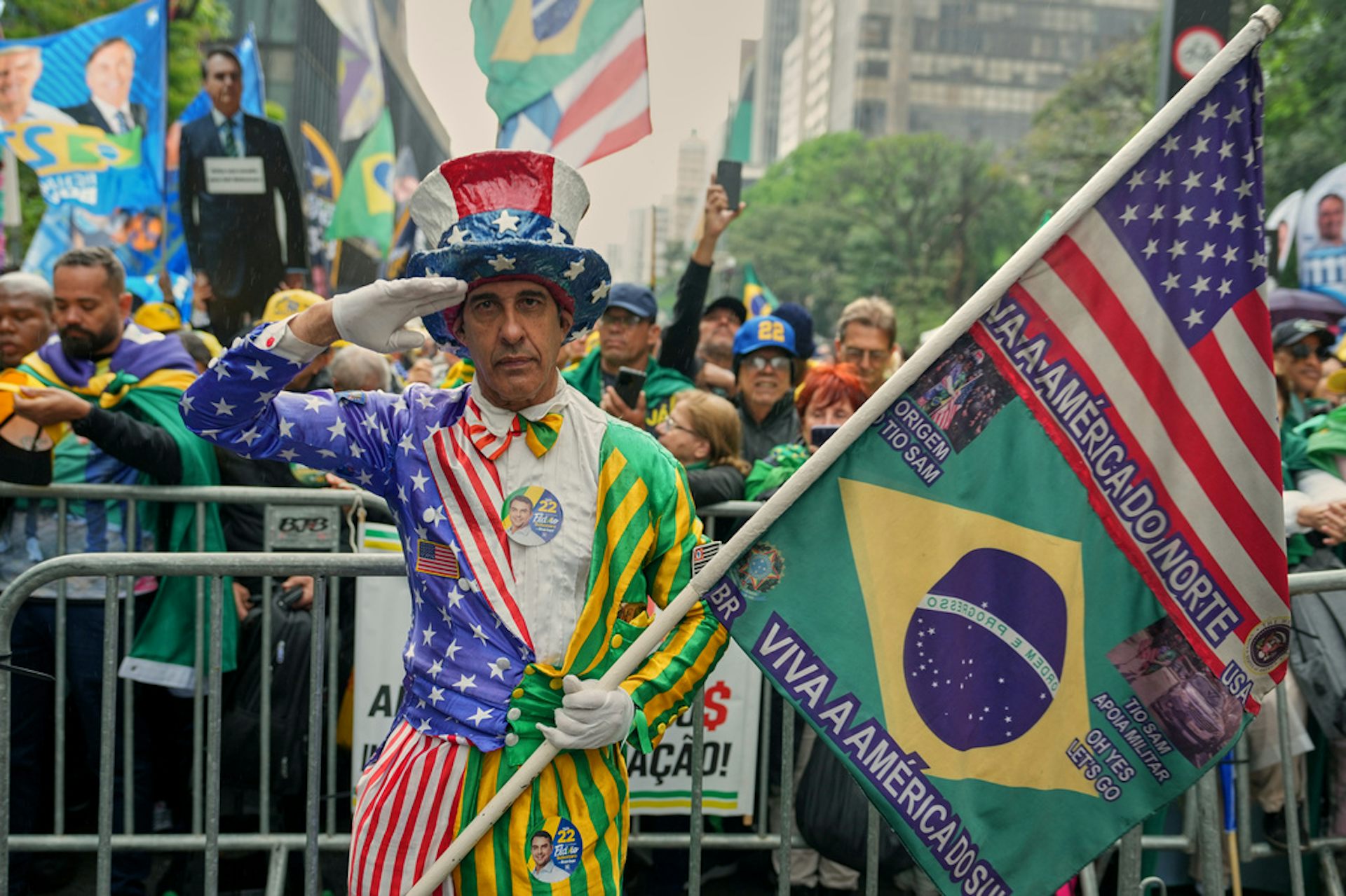 A demonstrator in a costume holds two flags.