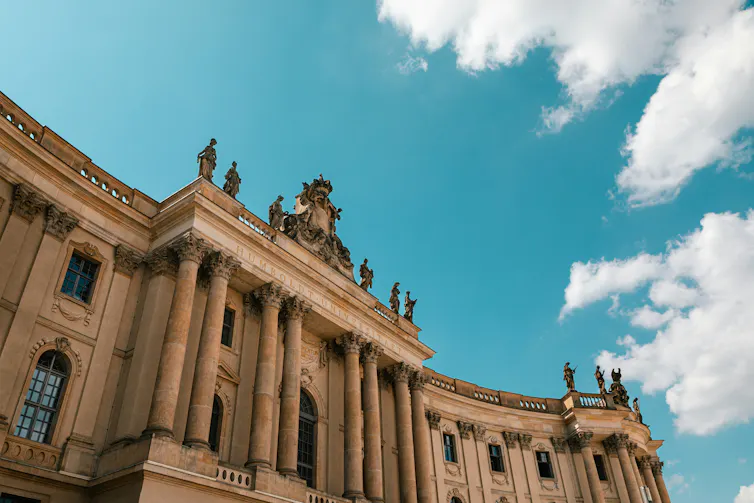 A large stone building against a blue sky.