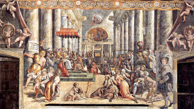 A painting shows dozens of men, women and children gathered around people standing on an ornate throne under a canopy.