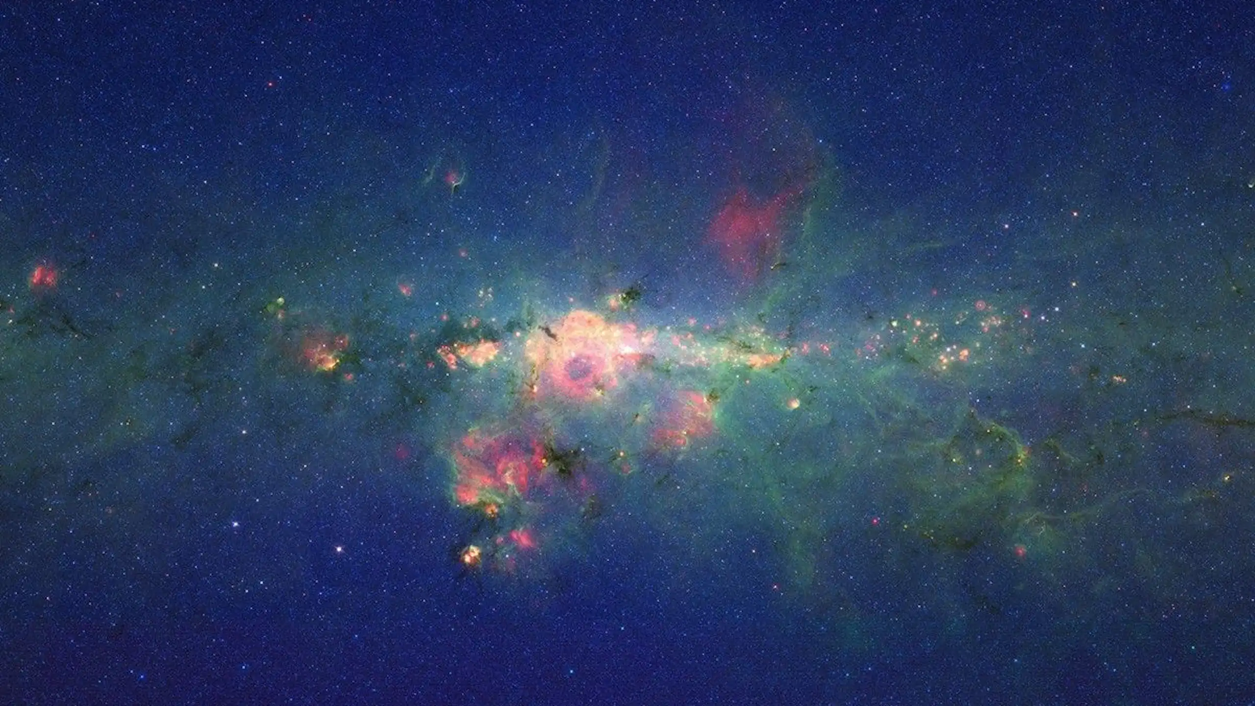 An image of space with beautiful pink green, orange, yellow colours against a deep blue background