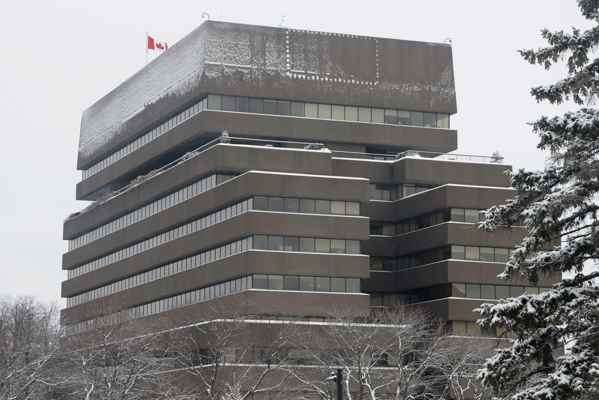 A concrete building on a snowy day.