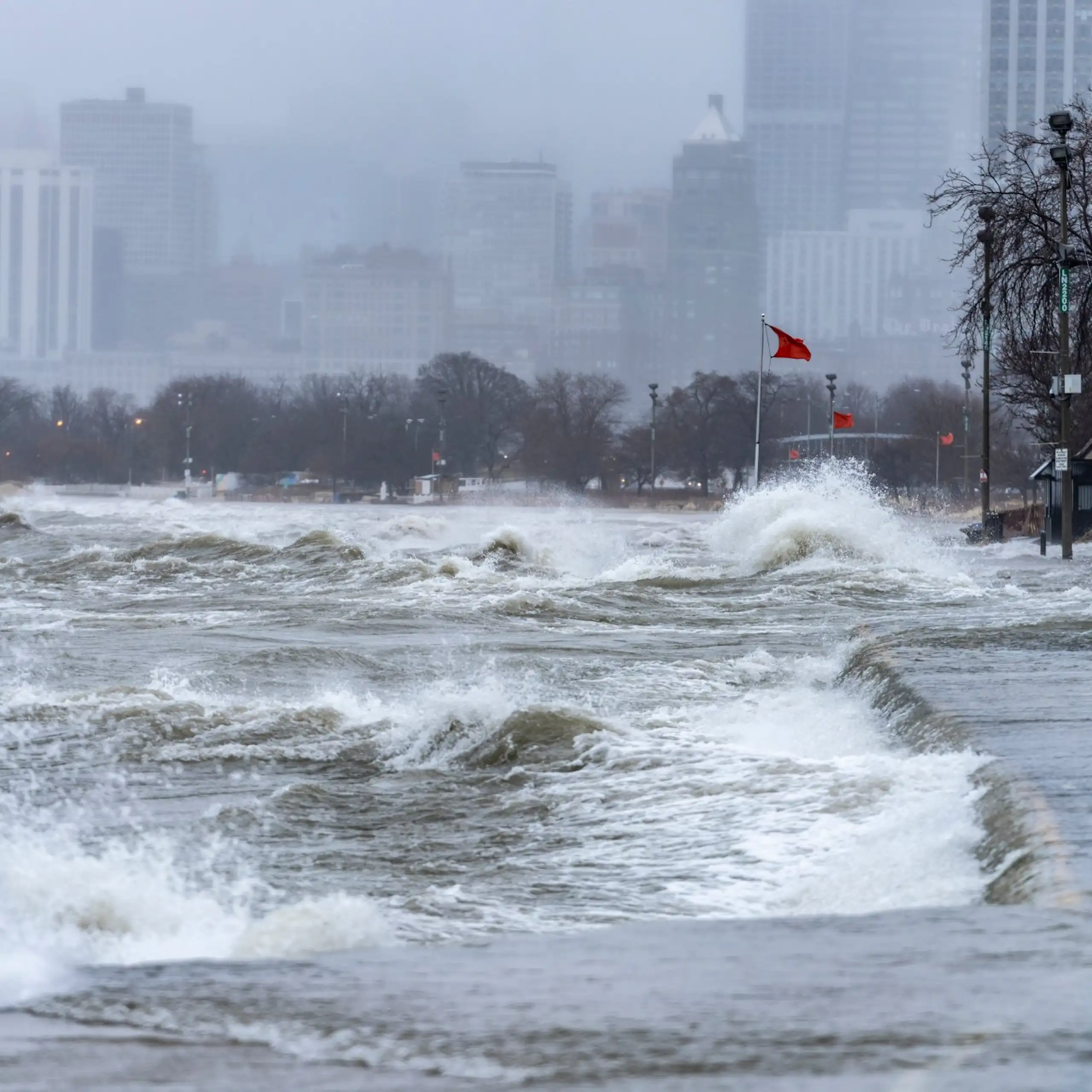 Waves crash against the shore of a flooded beach
