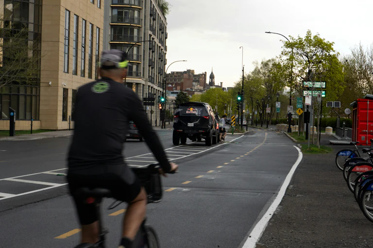 A cyclist and a car on the move.
