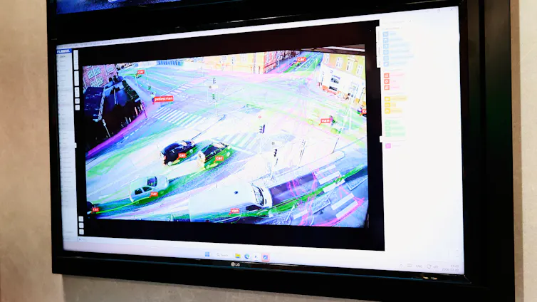 a video screen showing traffic in a city intersection with annotations