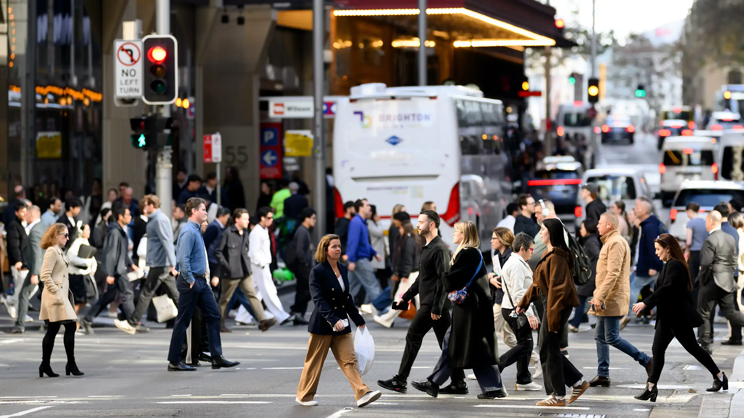 People are seen crossing the road in Sydney, June 2026