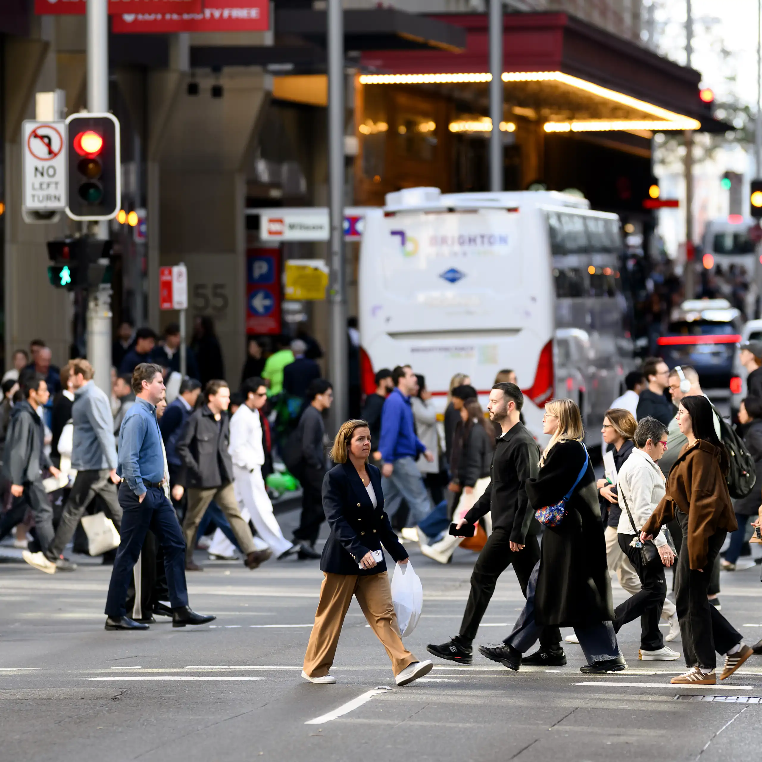 People are seen crossing the road in Sydney, June 2026