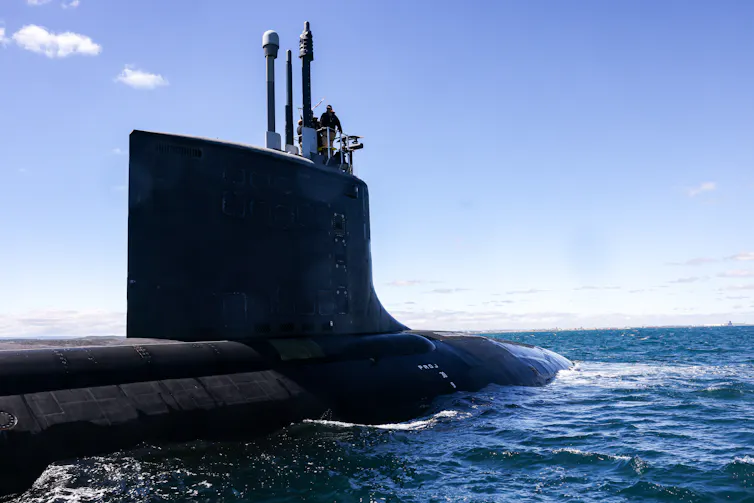 The USS Minnesota, a Virginia-class fast attack submarine, seen above the water.