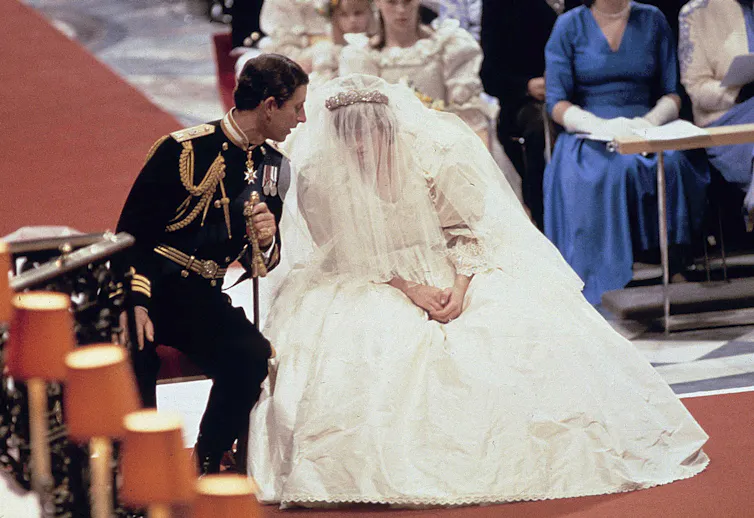 Prince Charles talks to a veiled Princess Diana on her wedding day.