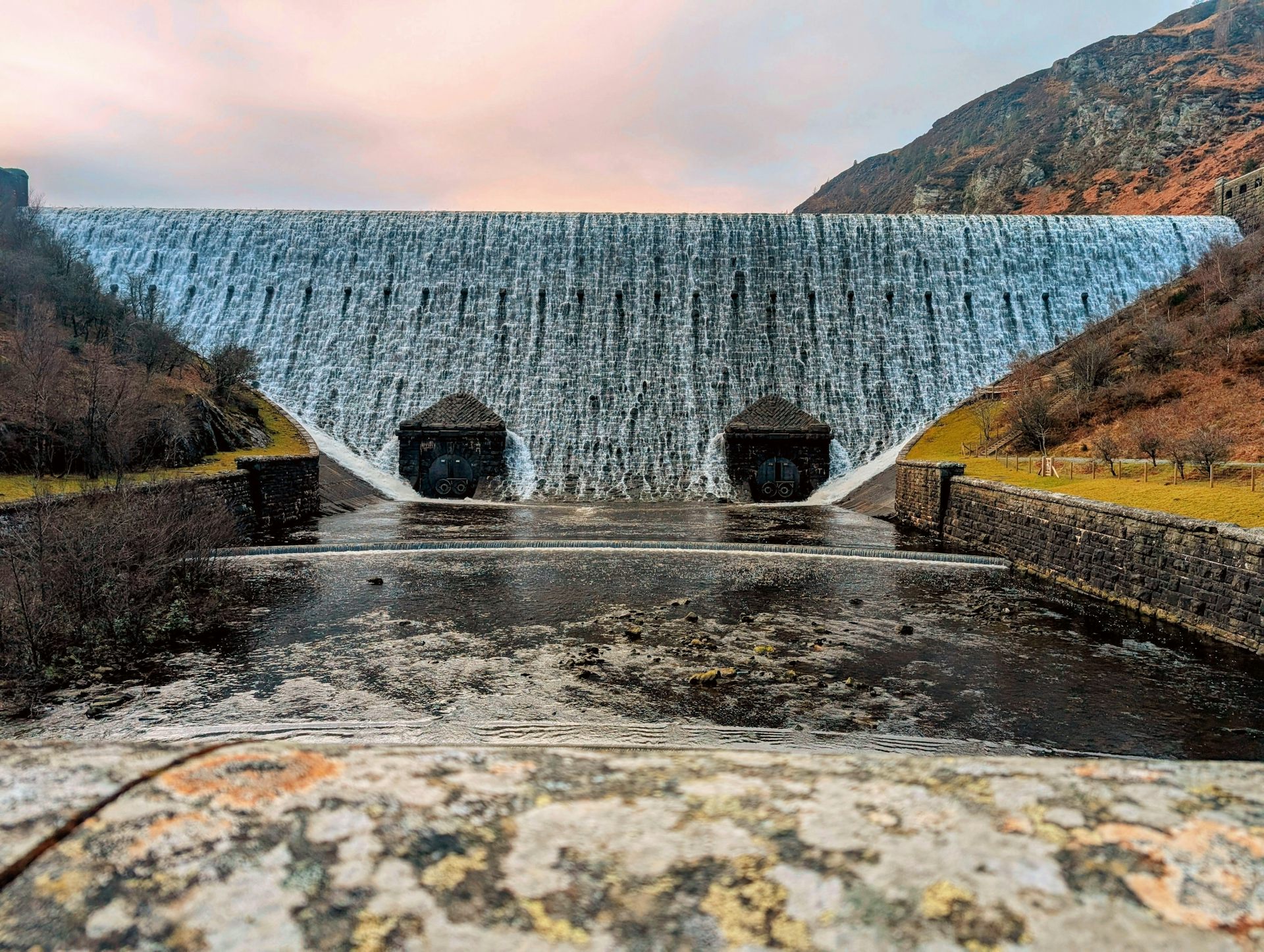 water flowing down dramatic dam in rural area