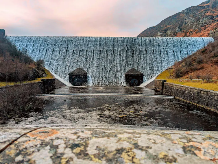 water flowing down dramatic dam in rural area