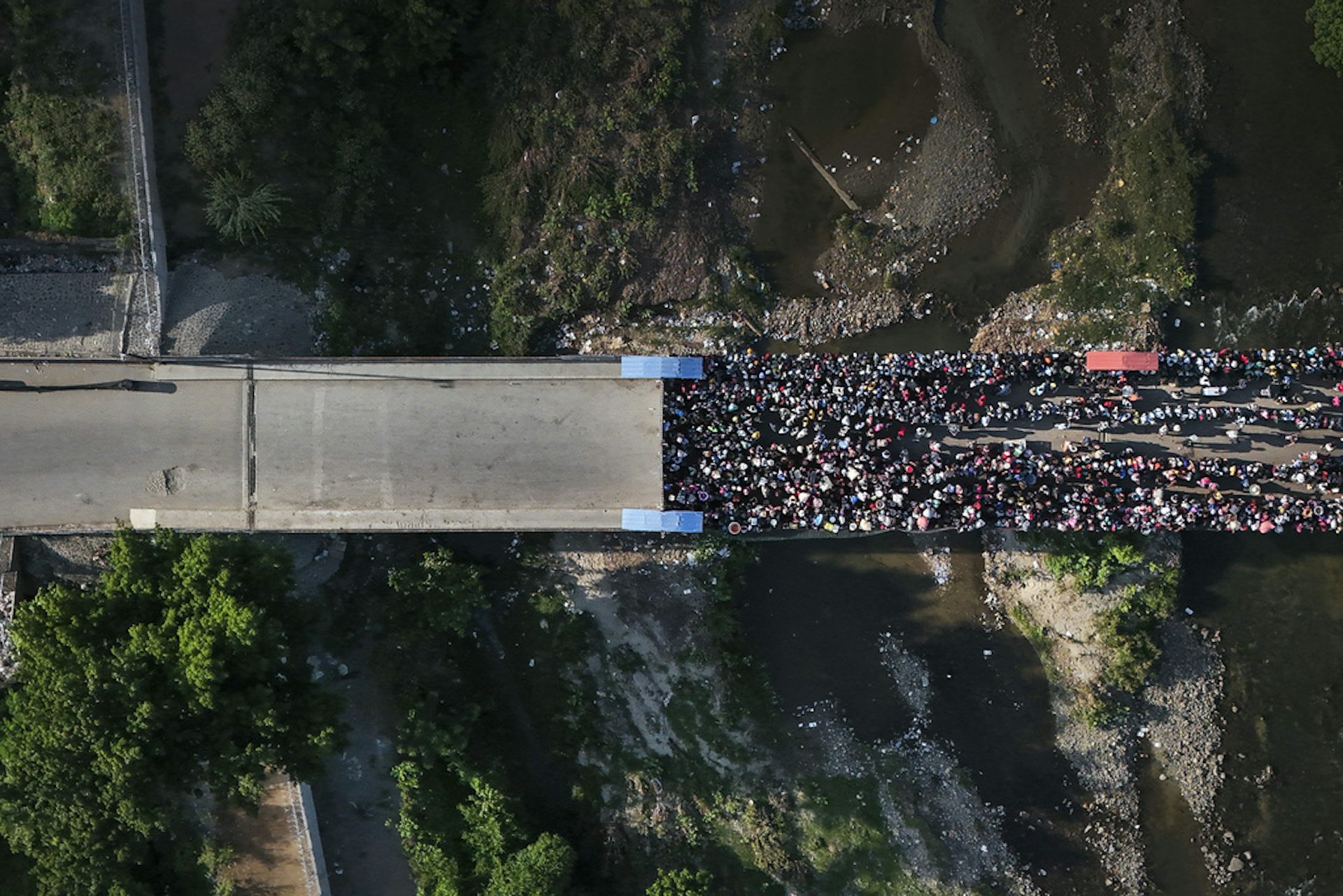 A bird's-eye view of a large crowd on a road.