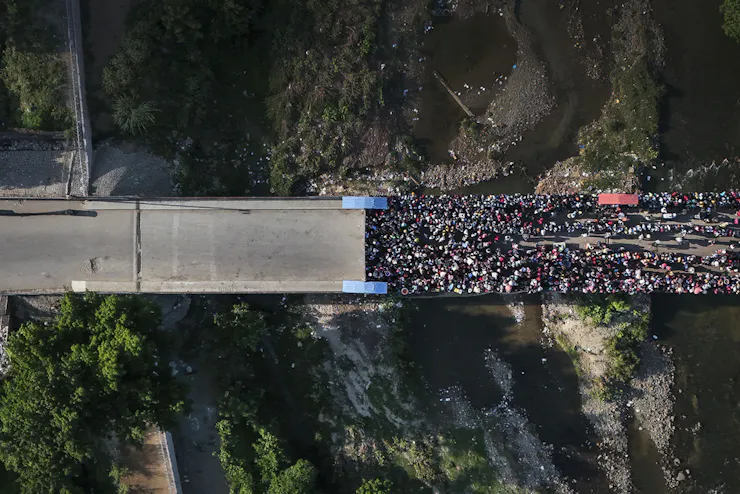 A bird's-eye view of a large crowd on a road.
