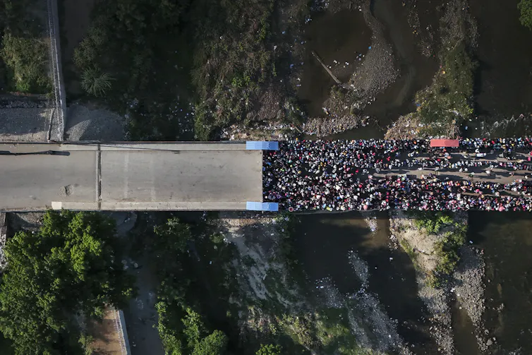 A bird's-eye view of a large crowd on a road.